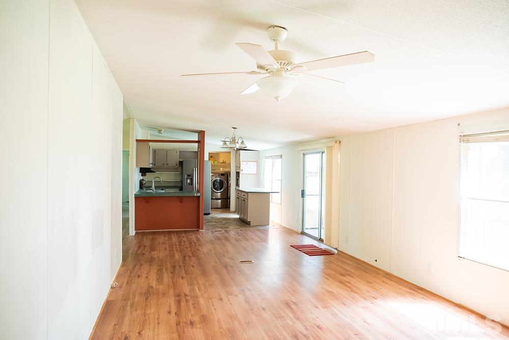 800 Woodsdale Road Roxboro, NC 27574 - Photo 17 of 54 a view of a room with wooden floor a ceiling fan and windows