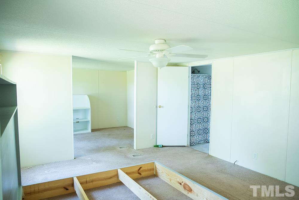 800 Woodsdale Road Roxboro, NC 27574 - Photo 23 of 54 an empty room with closet and a ceiling fan