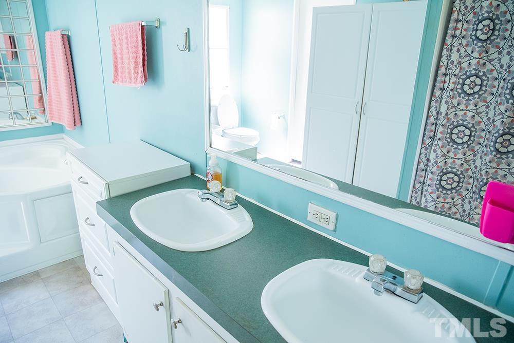 800 Woodsdale Road Roxboro, NC 27574 - Photo 27 of 54 a bathroom with a sink and a mirror