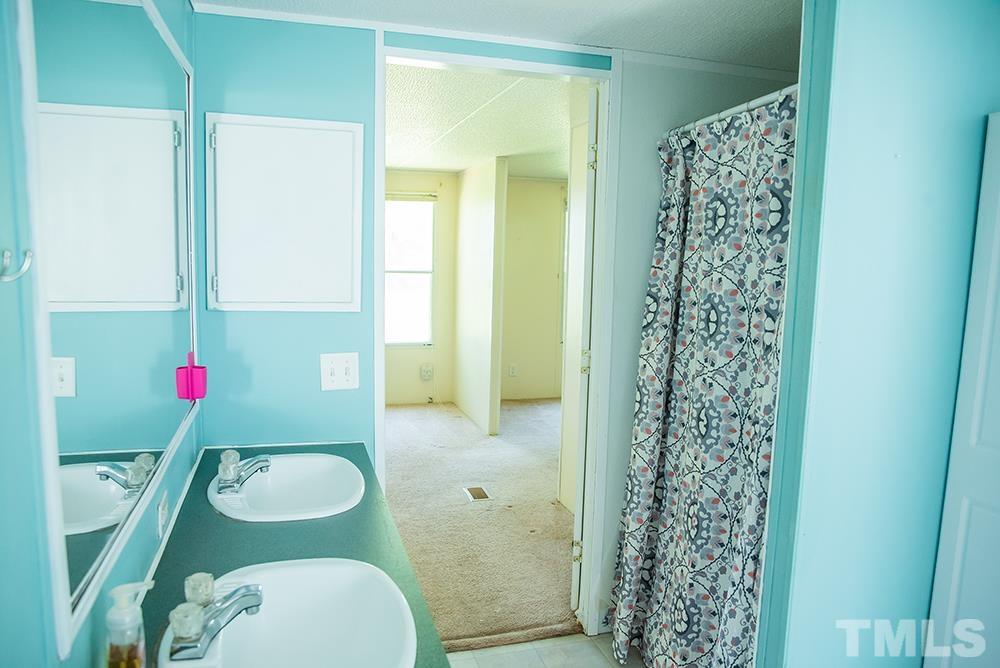 800 Woodsdale Road Roxboro, NC 27574 - Photo 30 of 54 a bathroom with a sink toilet and shower