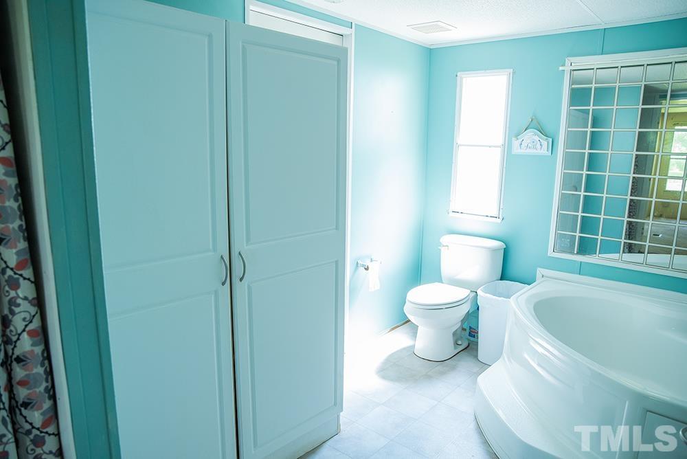 800 Woodsdale Road Roxboro, NC 27574 - Photo 31 of 54 a bathroom with a toilet and a sink