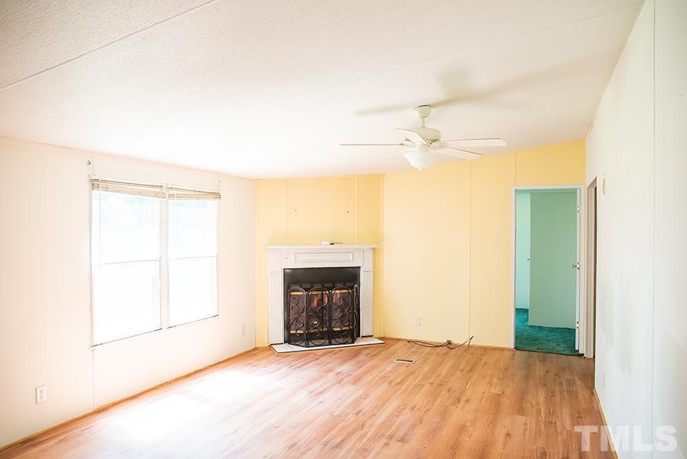 800 Woodsdale Road Roxboro, NC 27574 - Photo 33 of 54 an empty room with a fireplace and a window