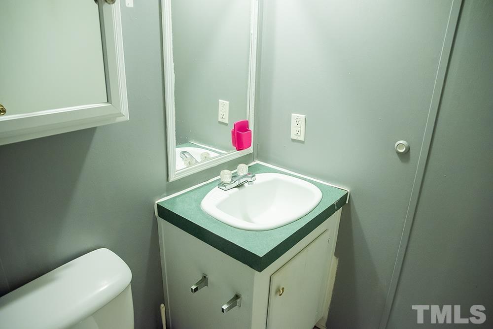 800 Woodsdale Road Roxboro, NC 27574 - Photo 41 of 54 a bathroom with a sink and a mirror