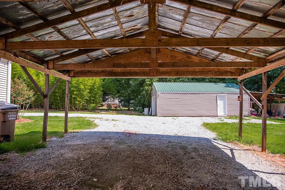 800 Woodsdale Road Roxboro, NC 27574 - Photo 42 of 54 a view of a backyard with floor to ceiling window and wooden fence