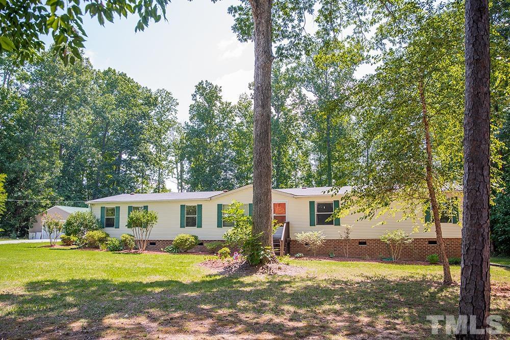 800 Woodsdale Road Roxboro, NC 27574 - Photo 53 of 54 a view of a house with backyard and sitting area