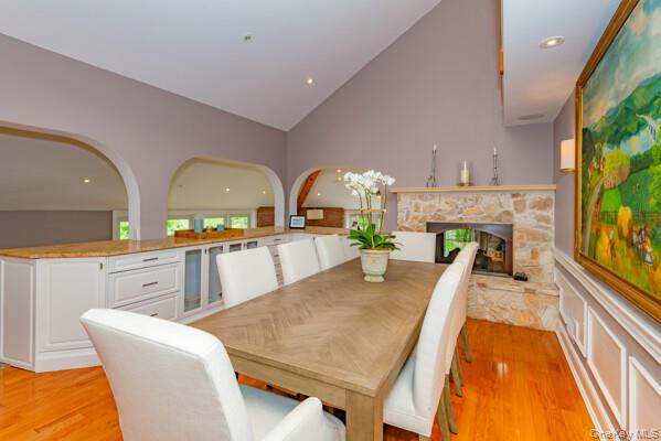 27 West Tiana Road Hampton Bays, NY 11946 - Photo 14 of 21 a living room with furniture a flat screen tv and a fireplace
