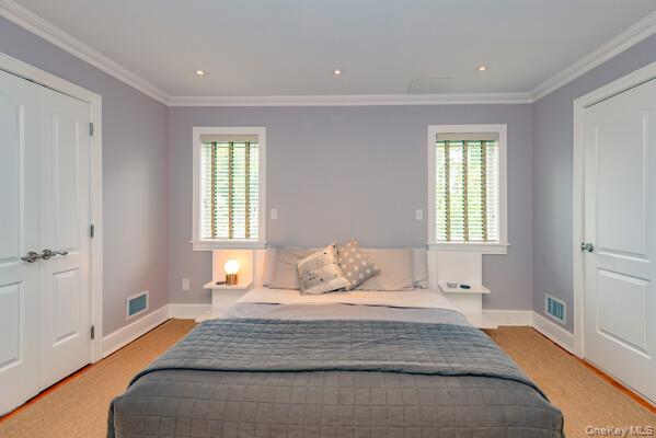 27 West Tiana Road Hampton Bays, NY 11946 - Photo 16 of 21 a bedroom with a bed and a window