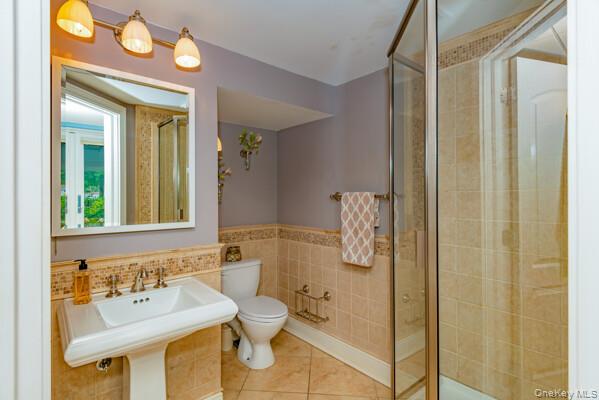 27 West Tiana Road Hampton Bays, NY 11946 - Photo 20 of 21 a bathroom with a sink a toilet and shower