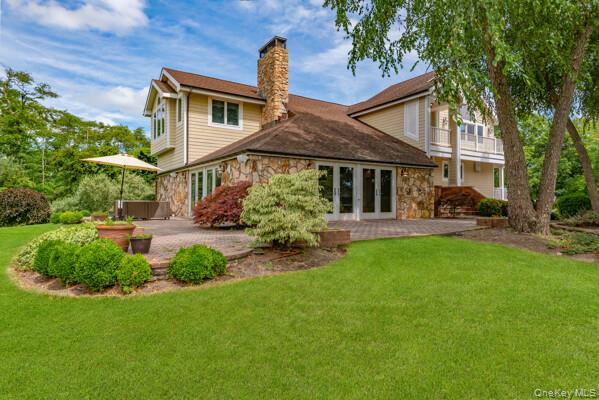 27 West Tiana Road Hampton Bays, NY 11946 - Photo 21 of 21 a front view of a house with garden