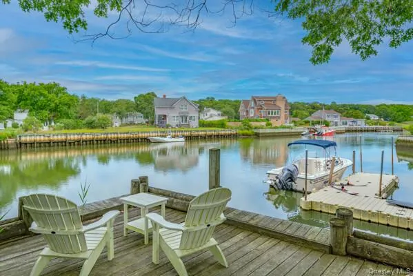 a view of a lake with a table and chairs