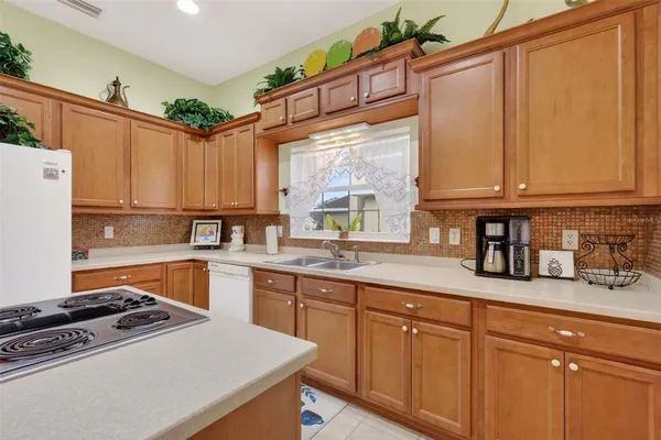 a kitchen with granite countertop a sink stainless steel appliances and cabinets
