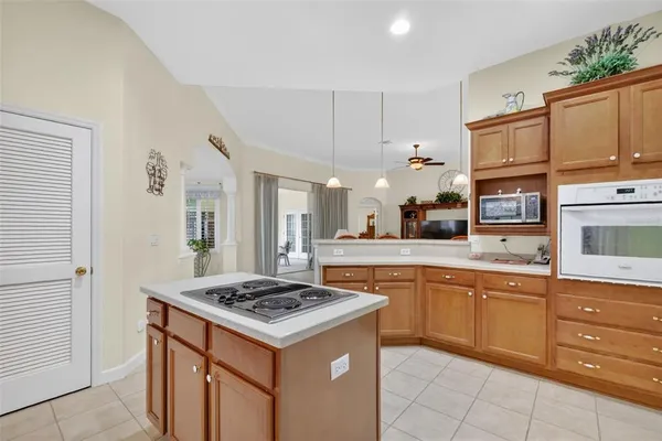 a kitchen with granite countertop cabinets and stove top oven