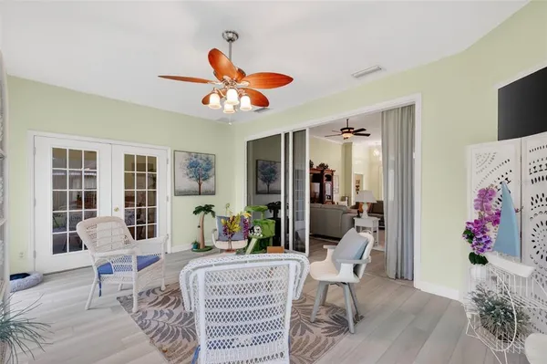 a living room with furniture chandelier and a window