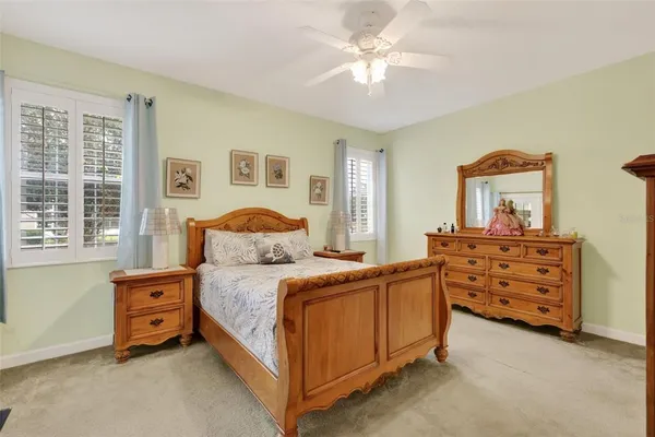 a bedroom with a bed a dresser and a window