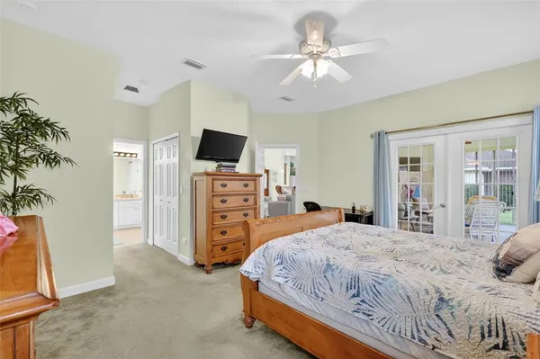 a bedroom with a large bed and flat tv