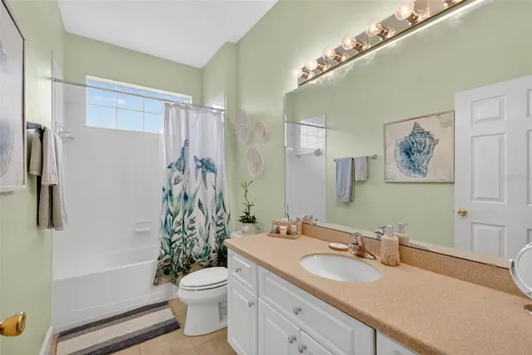 a bathroom with a double vanity sink toilet and shower