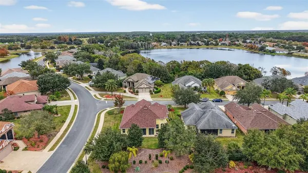 an aerial view of residential house with outdoor space and lake view