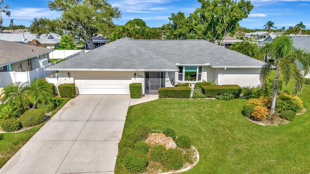 1235 Pine Needle Road Venice, FL 34285 - Photo 1 of 74 a front view of a house with garden