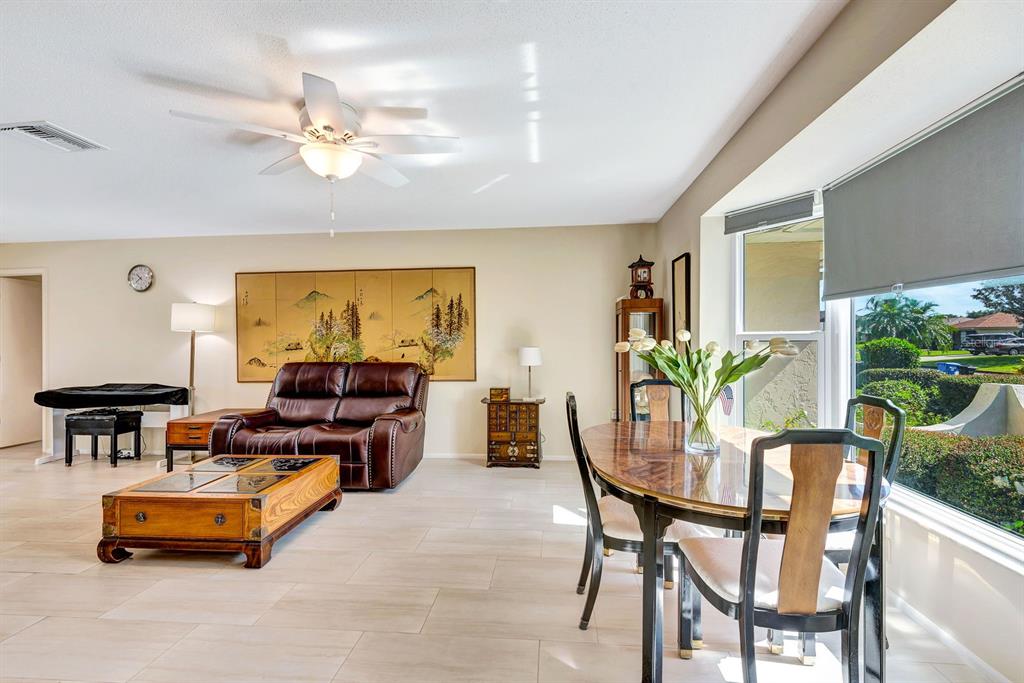 1235 Pine Needle Road Venice, FL 34285 - Photo 12 of 74 a living room with furniture and a large window