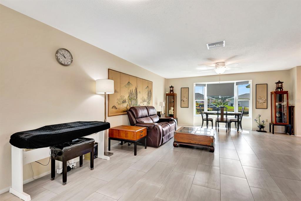 1235 Pine Needle Road Venice, FL 34285 - Photo 13 of 74 a living room with furniture and a table