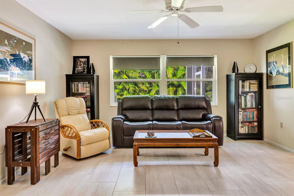 1235 Pine Needle Road Venice, FL 34285 - Photo 26 of 74 a living room with furniture and a large window