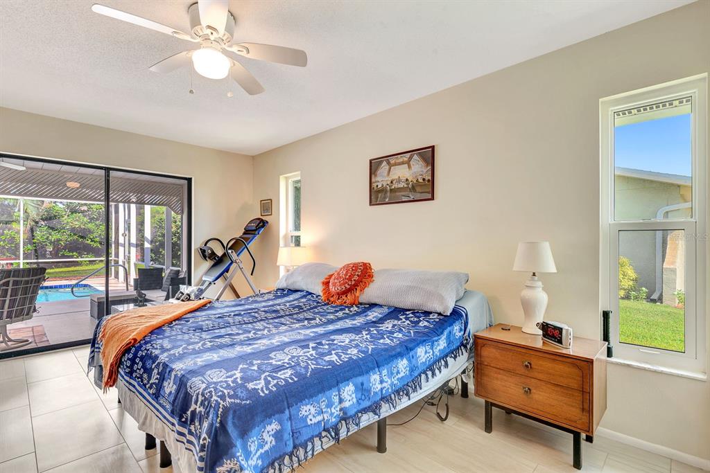 1235 Pine Needle Road Venice, FL 34285 - Photo 28 of 74 a bed room with a bed and a chandelier