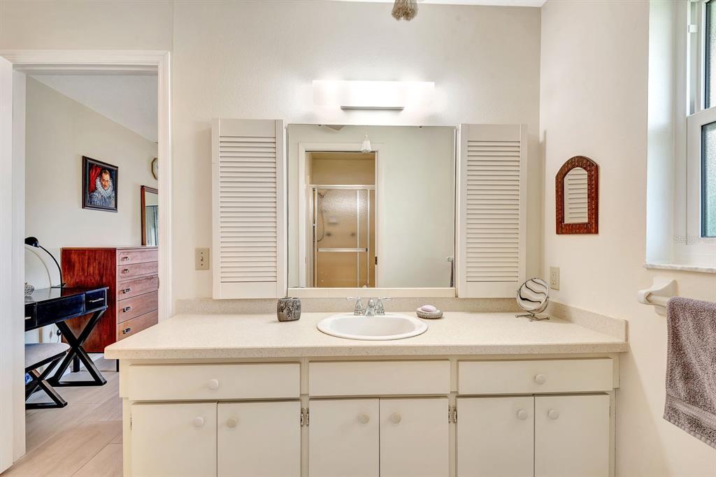 1235 Pine Needle Road Venice, FL 34285 - Photo 31 of 74 a bathroom with a sink and a mirror