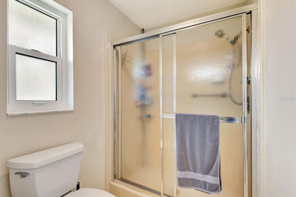 1235 Pine Needle Road Venice, FL 34285 - Photo 32 of 74 a bathroom that has a glass shower door