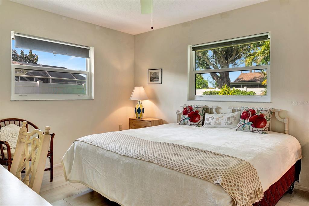 1235 Pine Needle Road Venice, FL 34285 - Photo 35 of 74 a bedroom with a bed and a painting on the wall