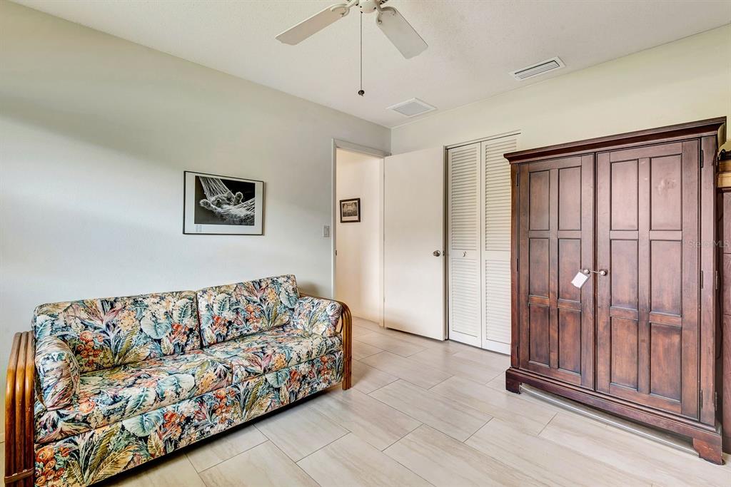 1235 Pine Needle Road Venice, FL 34285 - Photo 40 of 74 a living room with a couch and a chandelier