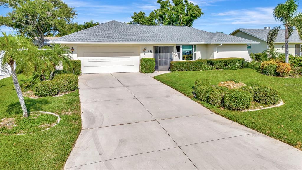 1235 Pine Needle Road Venice, FL 34285 - Photo 42 of 74 a front view of house with yard and green space