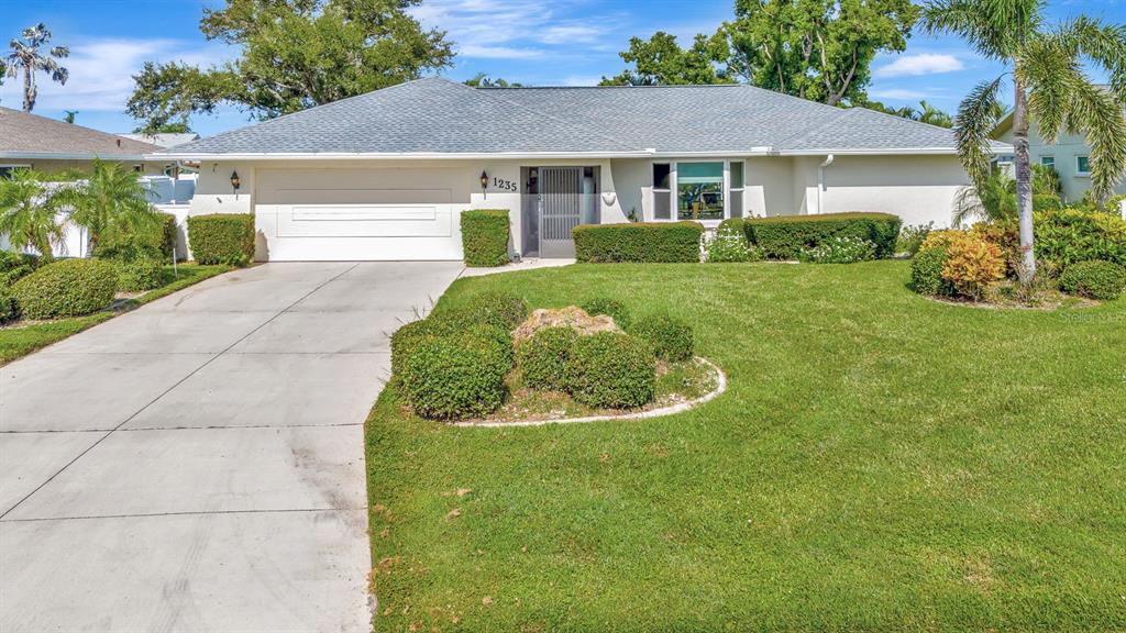 1235 Pine Needle Road Venice, FL 34285 - Photo 49 of 74 front view of a house with a yard