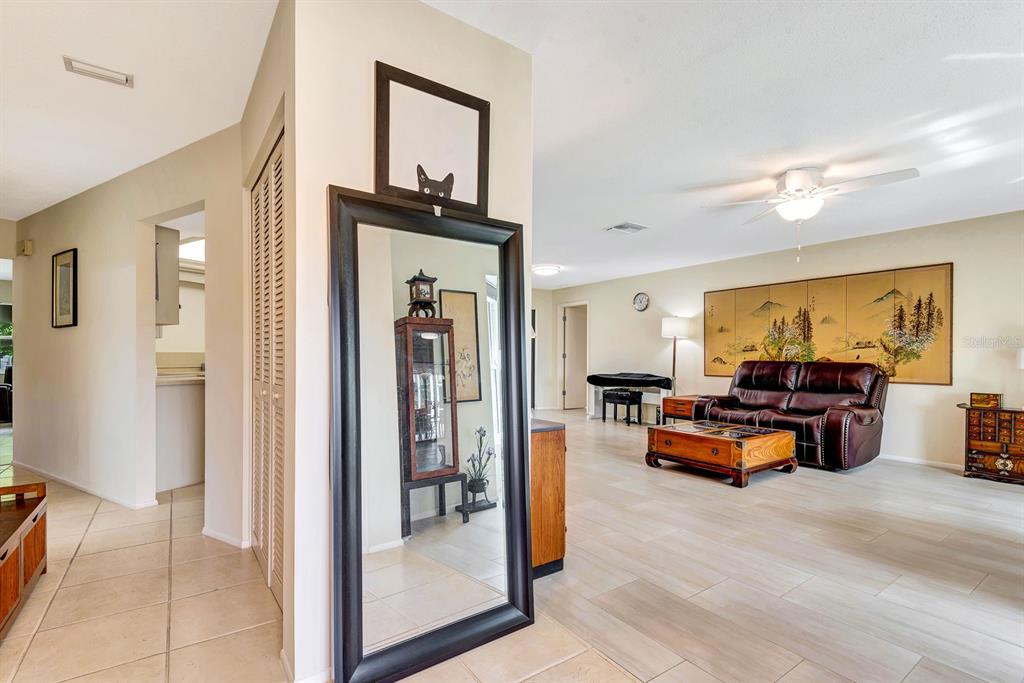 1235 Pine Needle Road Venice, FL 34285 - Photo 5 of 74 a living room with furniture and a flat screen tv