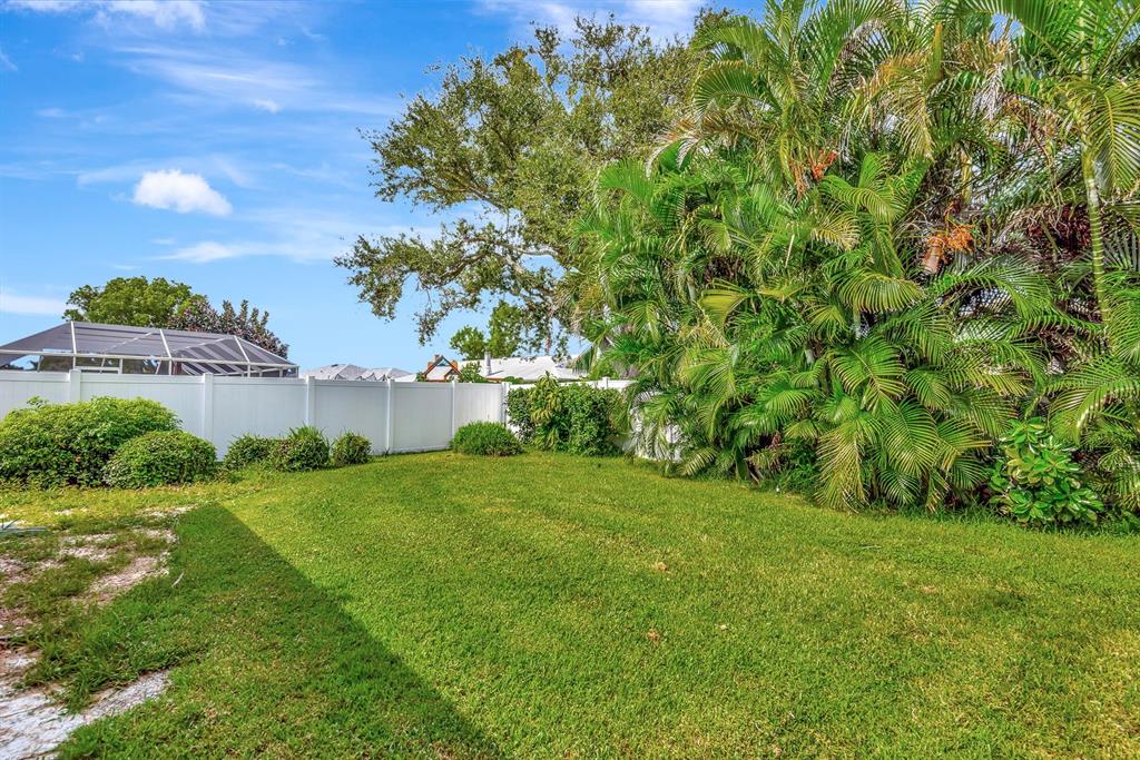 1235 Pine Needle Road Venice, FL 34285 - Photo 53 of 74 a view of a garden with a building in the background