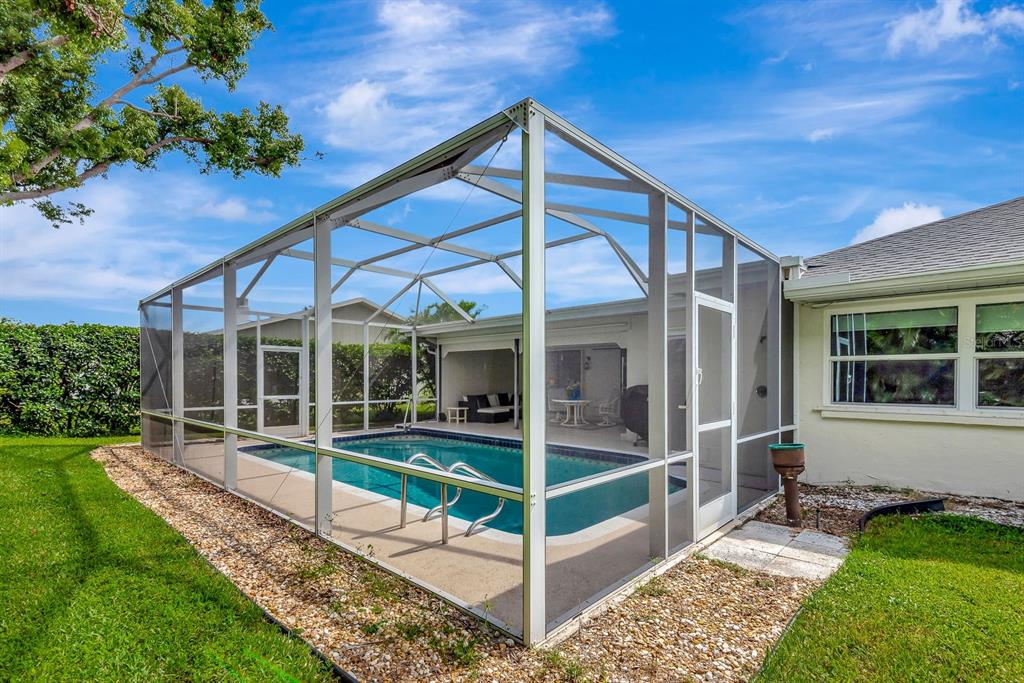1235 Pine Needle Road Venice, FL 34285 - Photo 54 of 74 a view of house with a big yard and potted plants