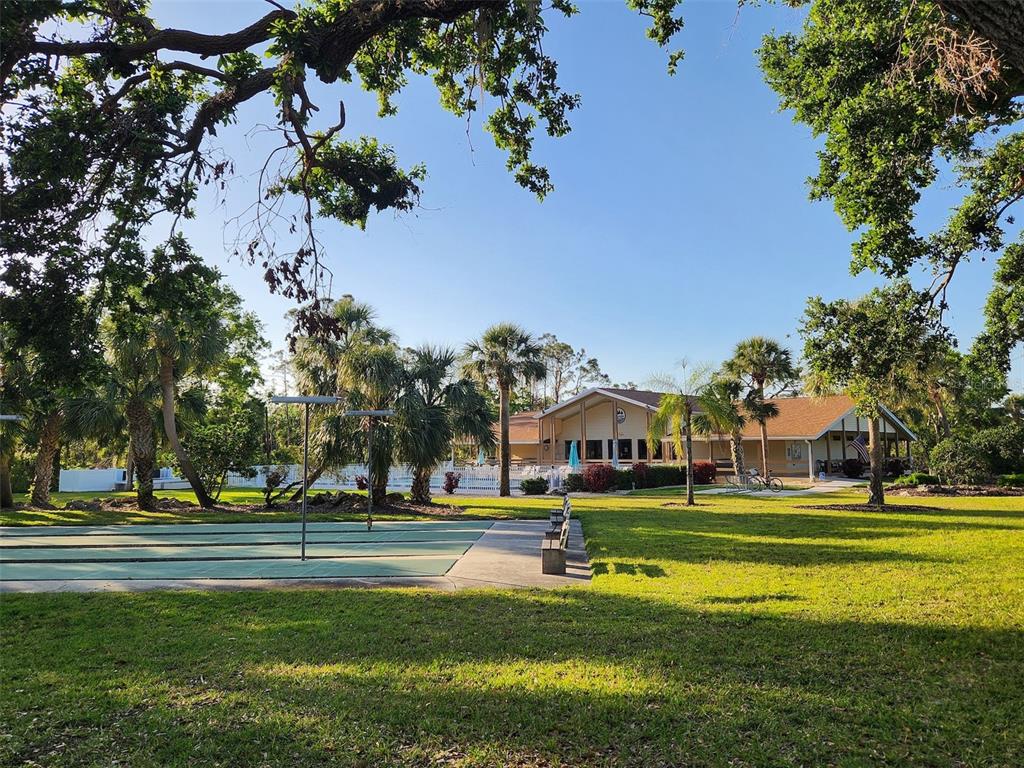 1235 Pine Needle Road Venice, FL 34285 - Photo 66 of 74 a view of swimming pool with outdoor seating and trees
