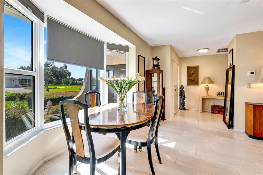 1235 Pine Needle Road Venice, FL 34285 - Photo 8 of 74 a view of a dining room with furniture window and outside view