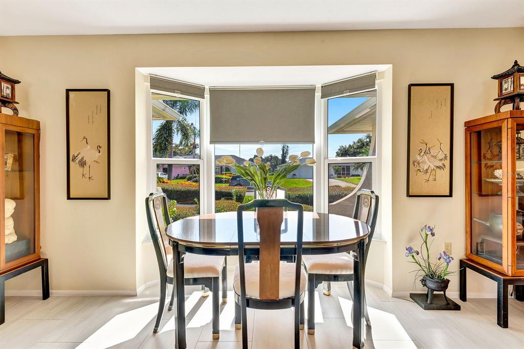 1235 Pine Needle Road Venice, FL 34285 - Photo 9 of 74 a dining room with furniture and window
