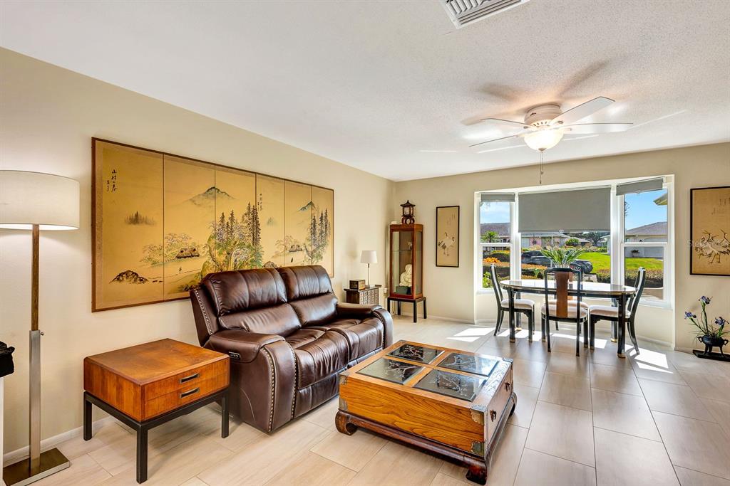 1235 Pine Needle Road Venice, FL 34285 - Photo 10 of 74 a living room with furniture and a large window