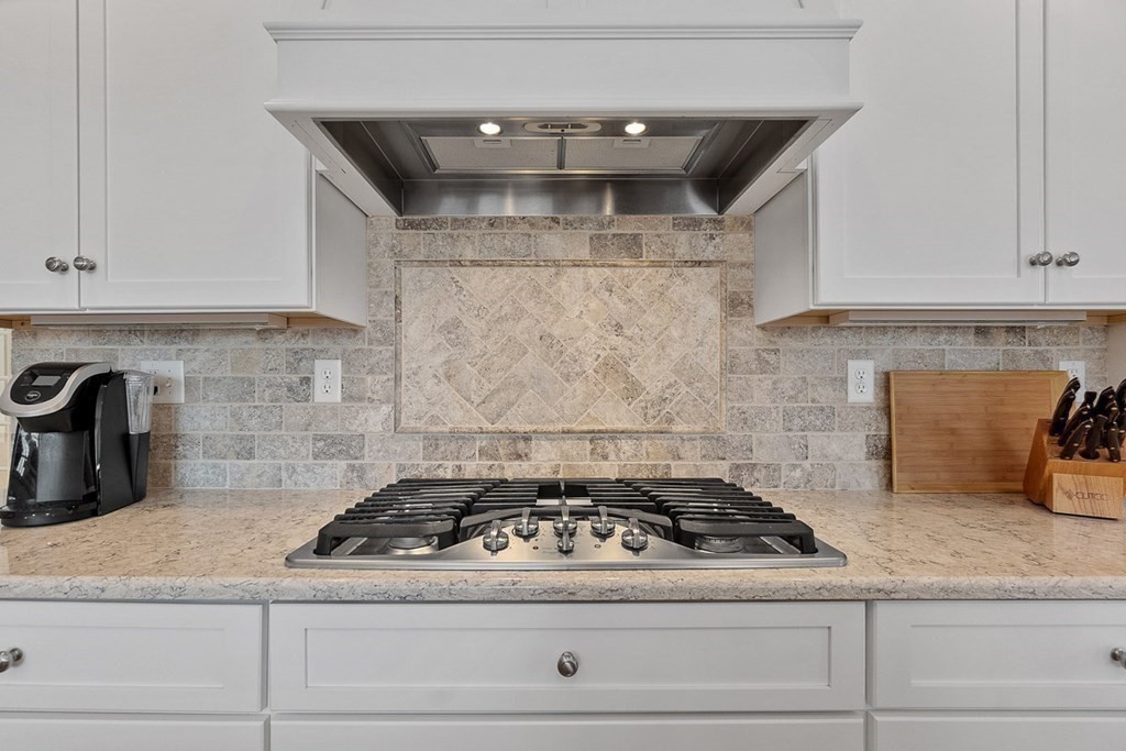 212 Hawthorne Lane Concord, MA 01742 - Photo 11 of 41 a stove top oven sitting inside of a kitchen