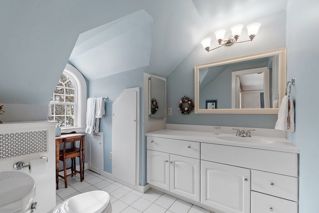 212 Hawthorne Lane Concord, MA 01742 - Photo 29 of 41 a bathroom with a sink vanity granite toilet and a mirror