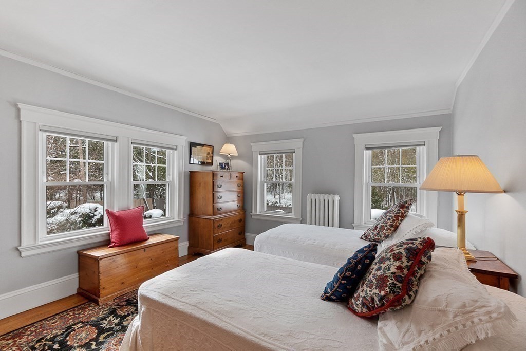 212 Hawthorne Lane Concord, MA 01742 - Photo 30 of 41 a bedroom with a bed and wooden floor