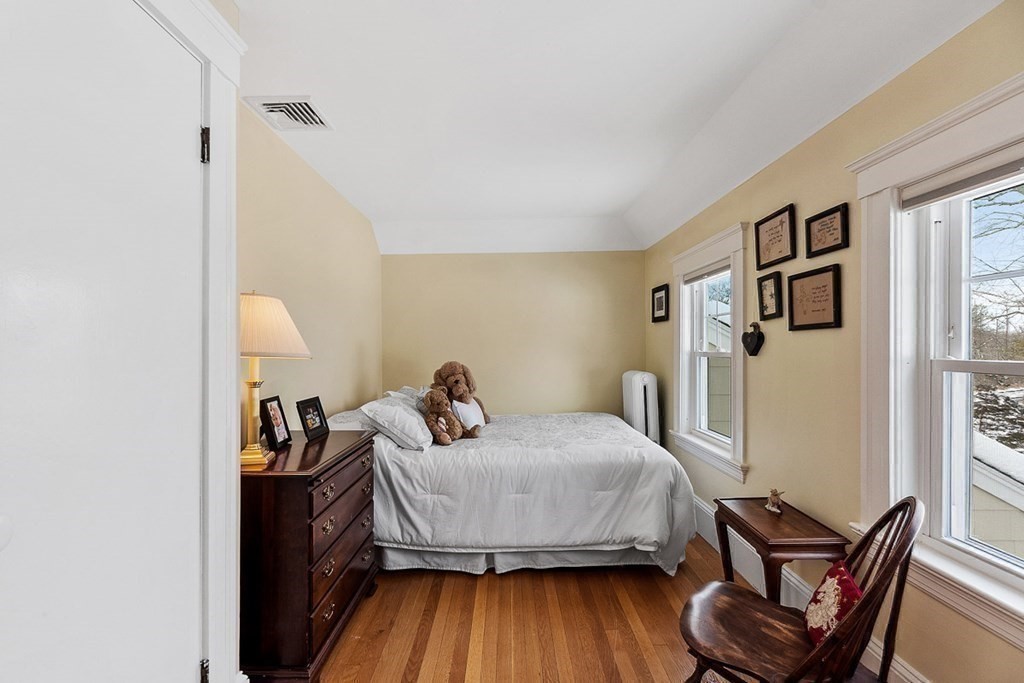 212 Hawthorne Lane Concord, MA 01742 - Photo 32 of 41 a bedroom with a bed and wooden floor