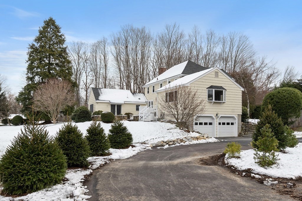 212 Hawthorne Lane Concord, MA 01742 - Photo 36 of 41 a front view of a house with a yard and garage