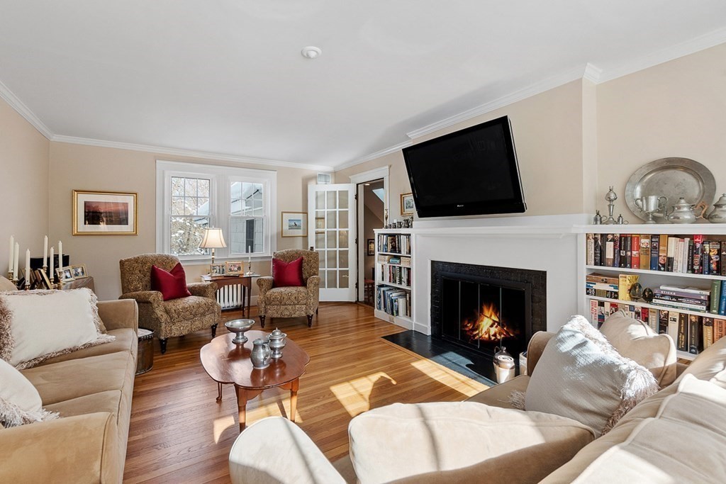 212 Hawthorne Lane Concord, MA 01742 - Photo 6 of 41 a living room with furniture a fireplace and a flat screen tv
