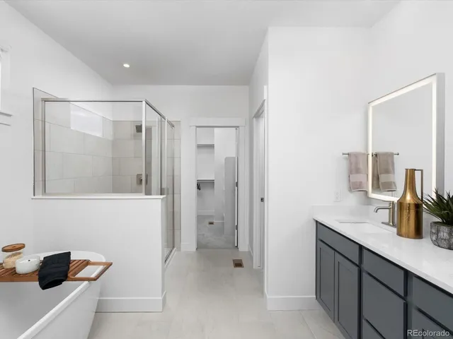 a bathroom with a shower sink and mirror