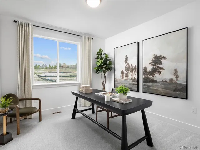 a view of a livingroom with furniture and a window