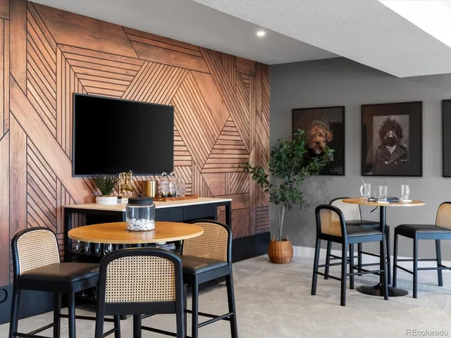 a bedroom with a bed lamp and a large window