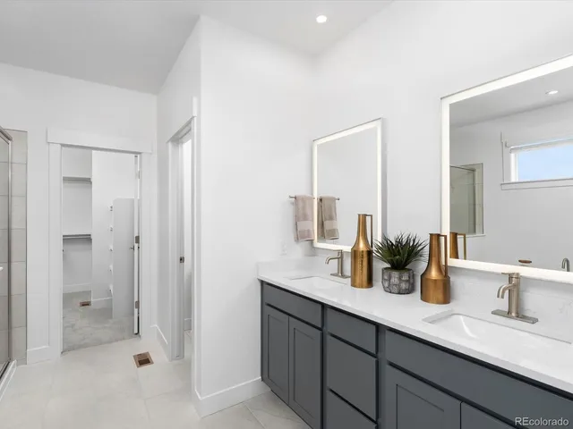 a bathroom with double sink and a mirror