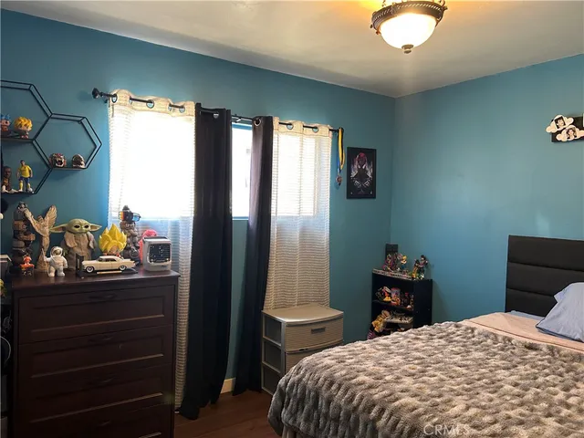 a bedroom with a bed and a dresser